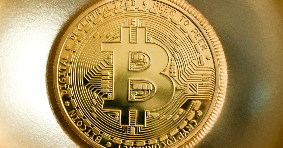 a gold bit coin sitting on top of a table