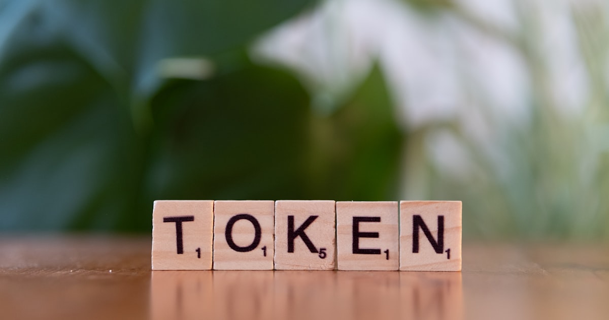 A wooden block that says token sitting on a table
