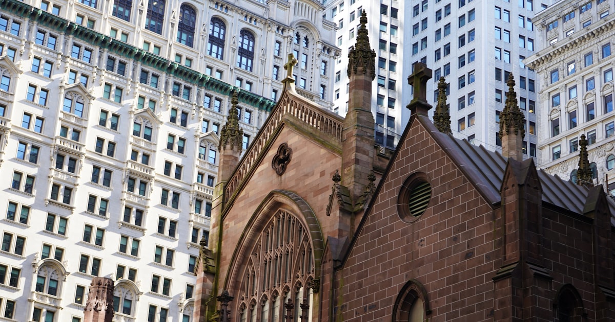 A church in a city surrounded by tall buildings