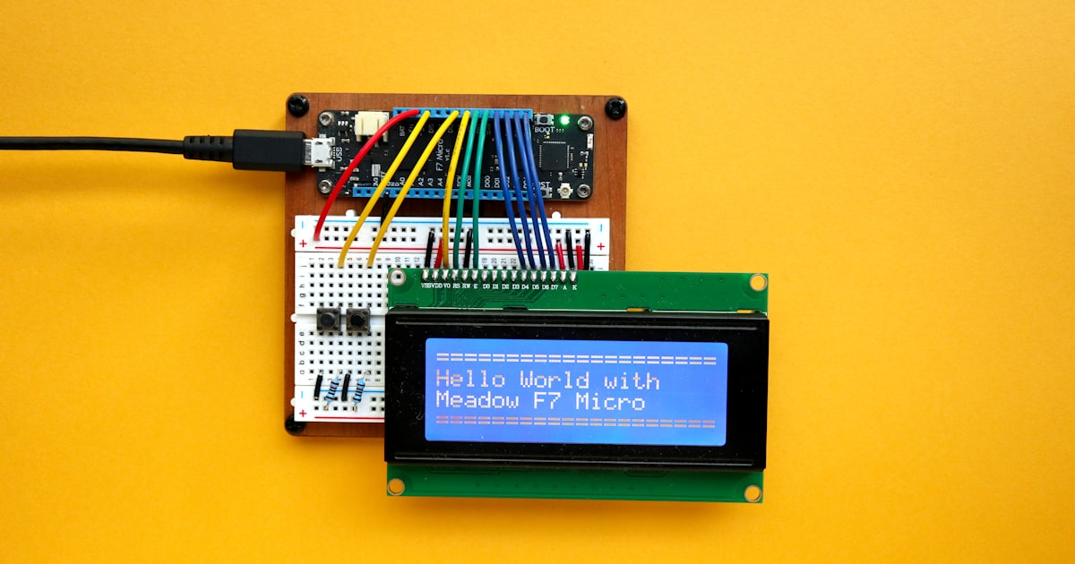 an electronic device with a blue screen on a yellow surface