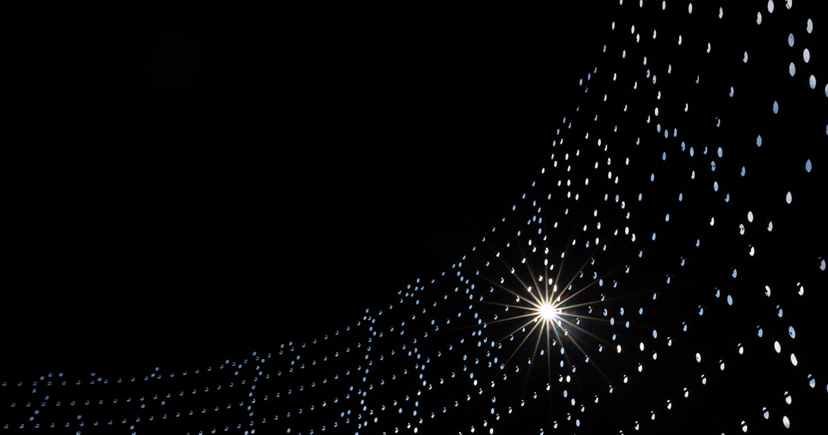 a black background with white dots and a star