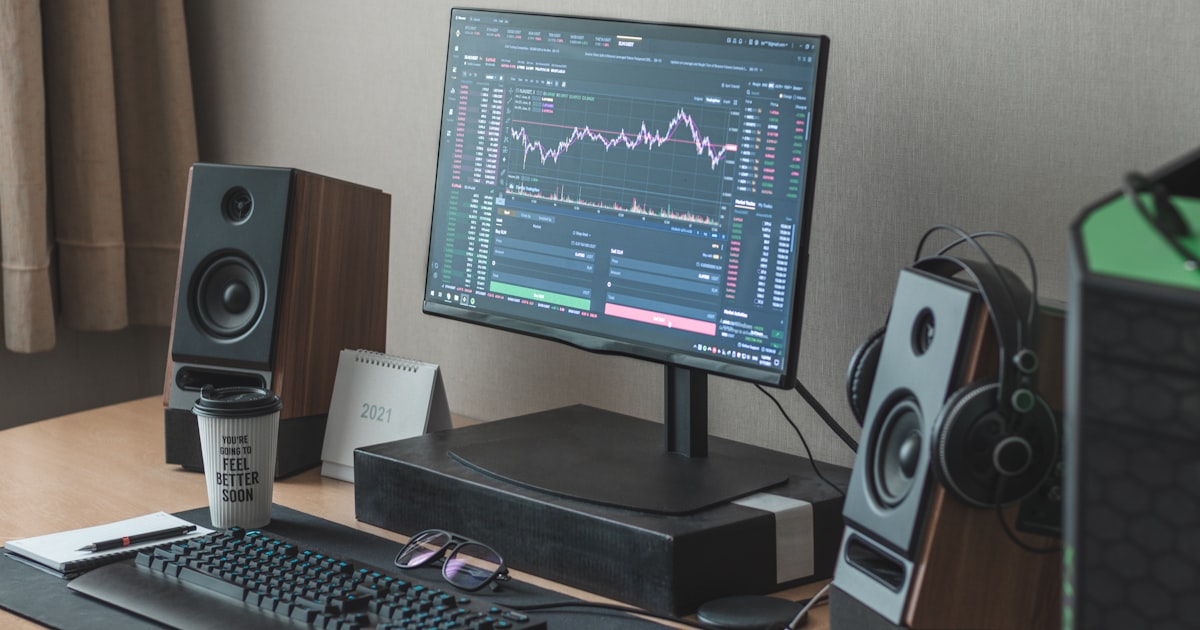 black flat screen computer monitor turned on beside black computer keyboard