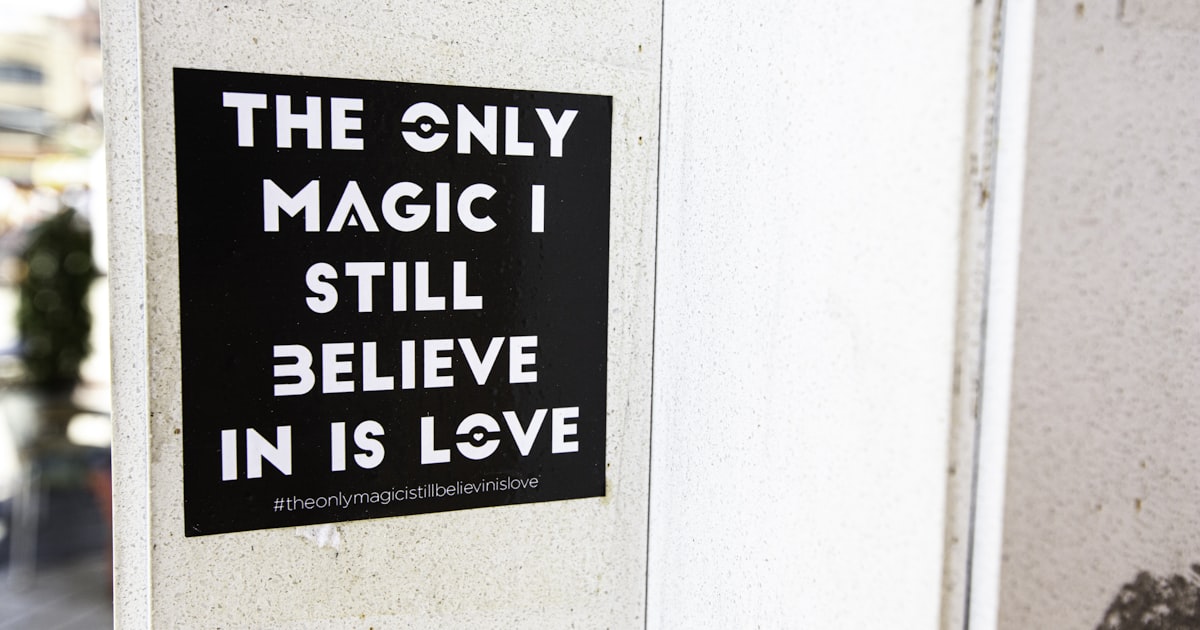 Black sticker declares love as the only magic.