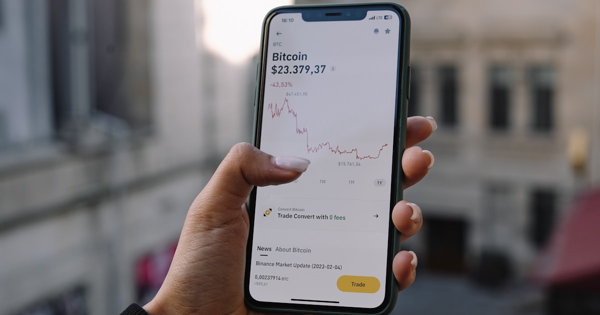 a person holding a cell phone in their hand