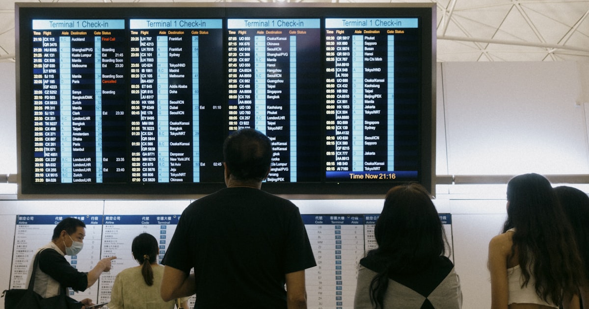 a group of people standing in front of a large screen