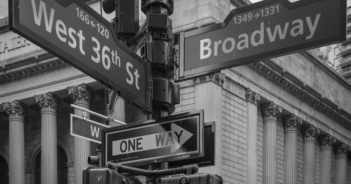 a black and white photo of a street sign