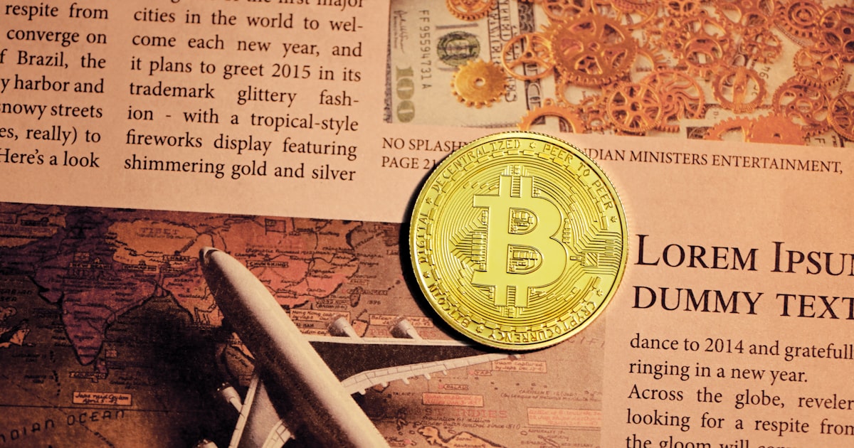 gold round coin on newspaper