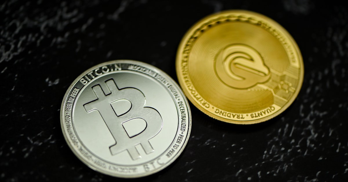 two bitcoins sitting side by side on a table
