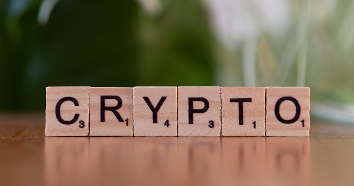 A wooden block spelling crypt on a table
