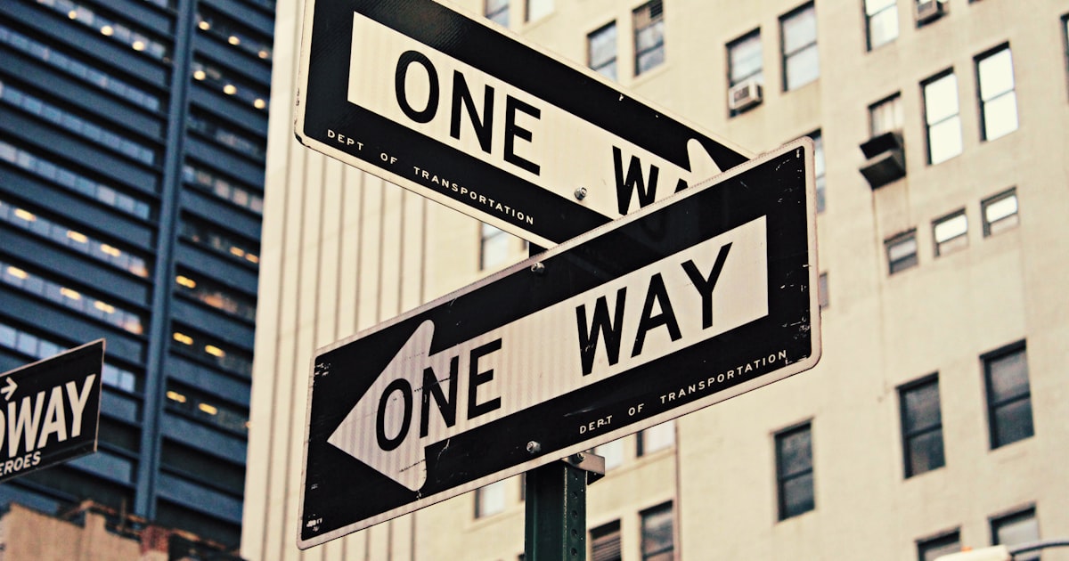 white and black One Way-printed road signages