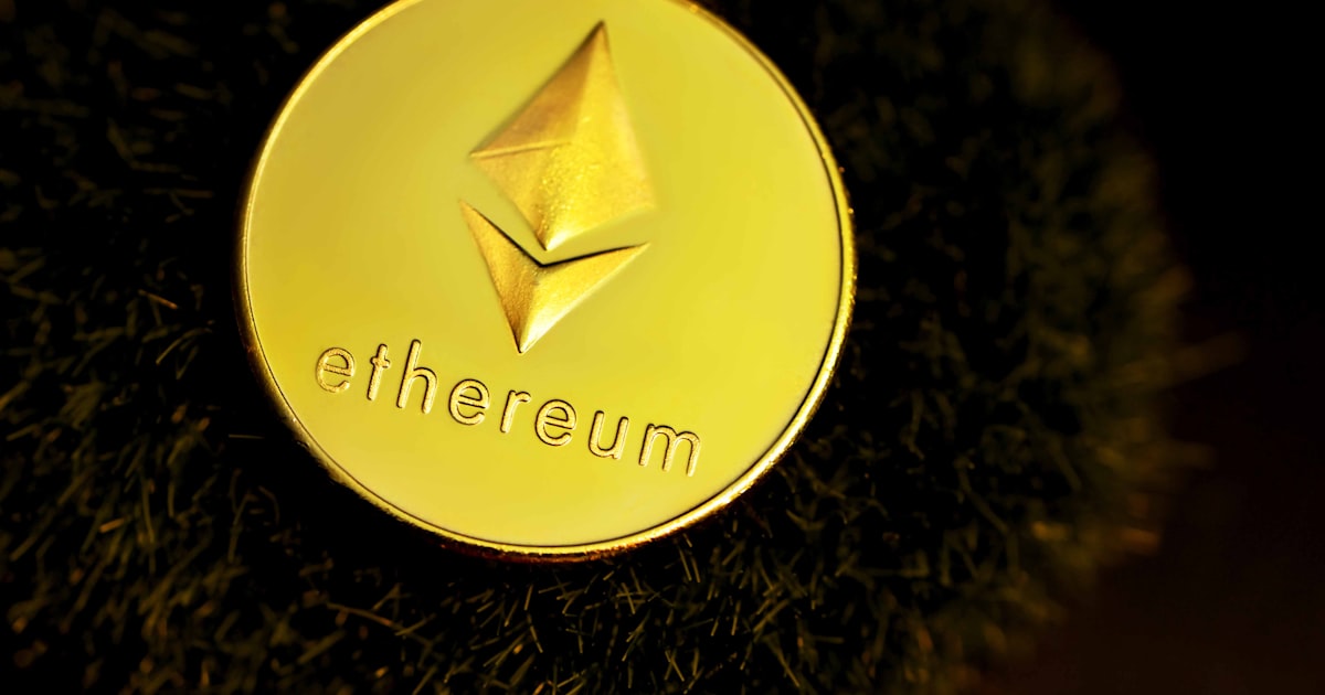 a close up of a gold coin with the word ether on it