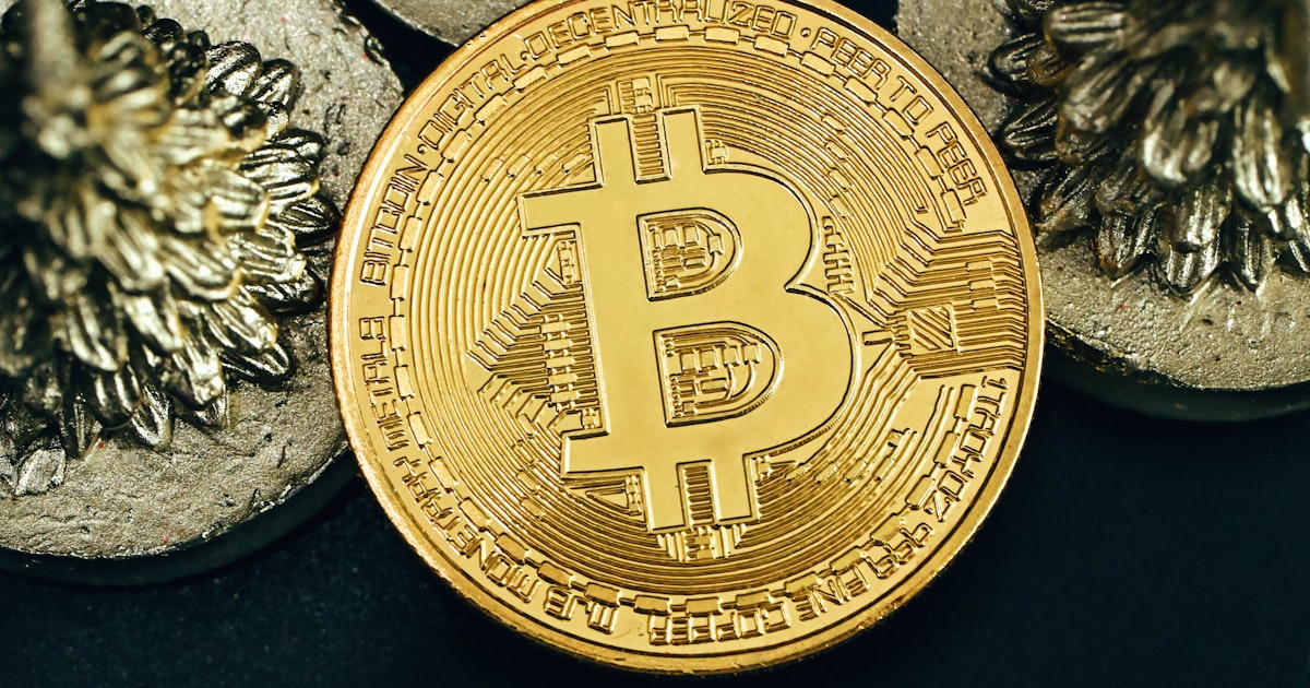 a bit coin sitting on top of a pile of coins