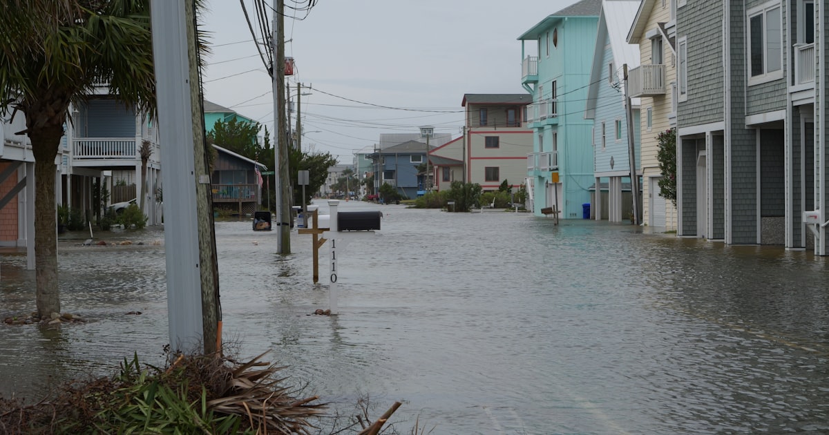 Street flooded with water and debris after storm.