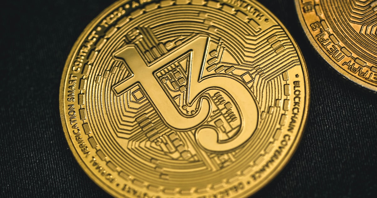 a close up of a gold coin with the letter s on it