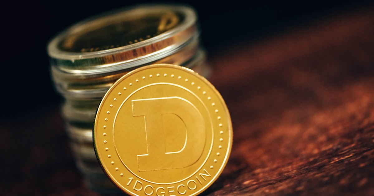 a stack of coins sitting on top of a wooden table