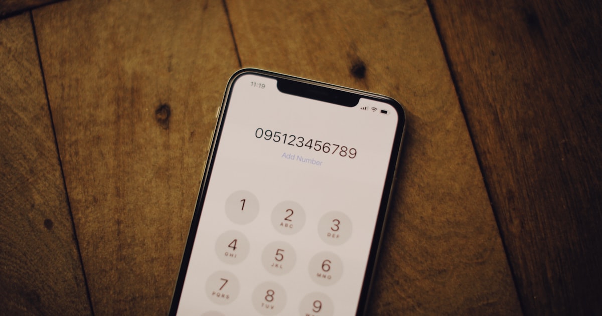 a cell phone sitting on top of a wooden table