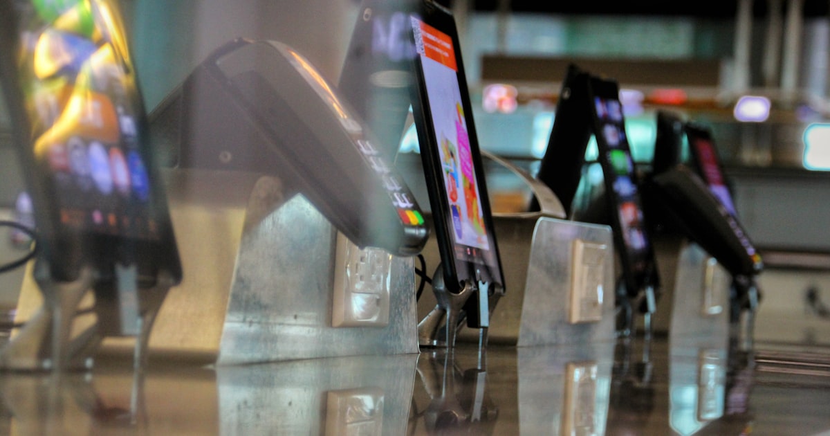 black and white smartphone on glass table