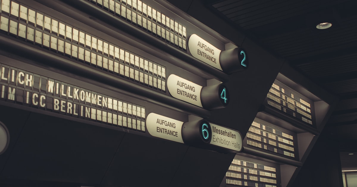 a bunch of signs hanging from the side of a building