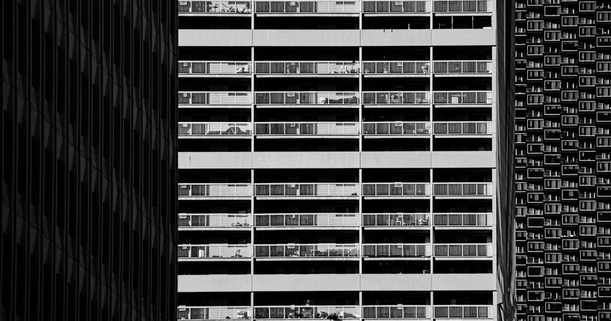 Modern building facade with repeating windows and textures.