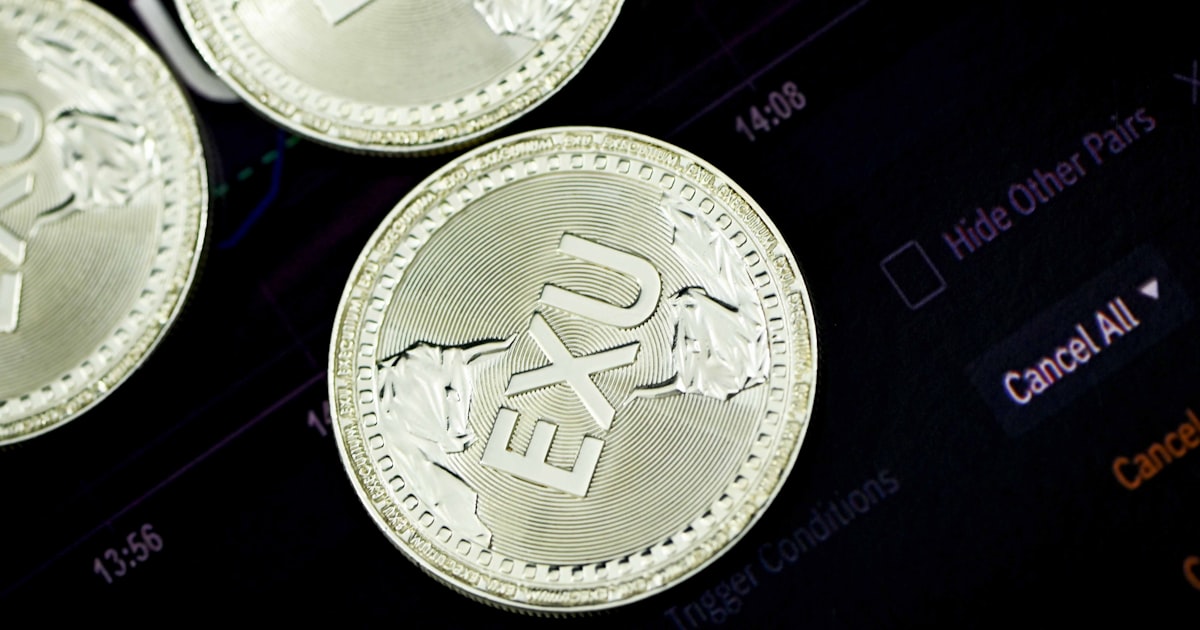 silver round coin on black surface