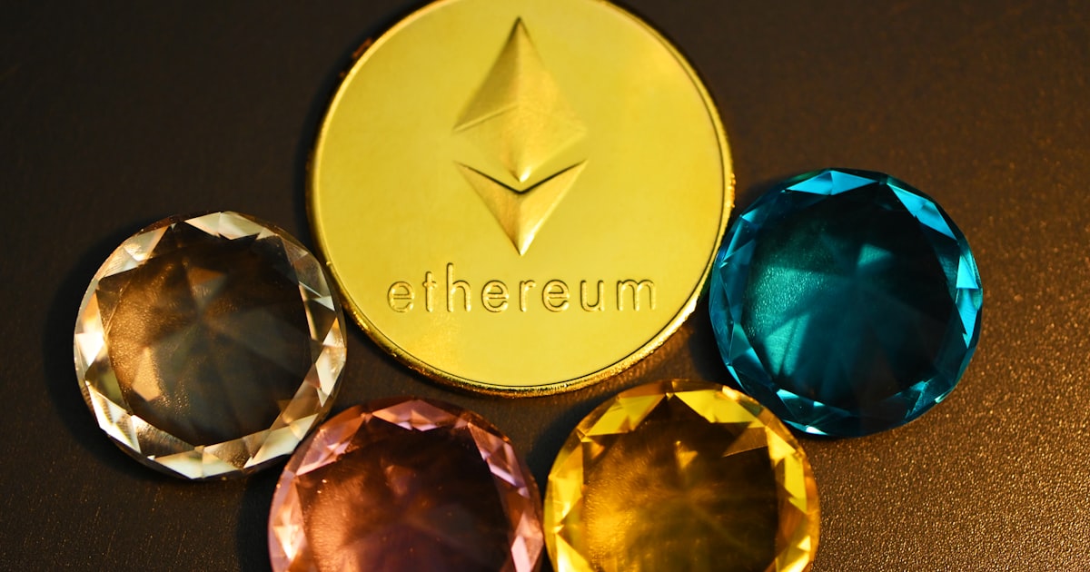 three different colored diamonds next to a gold coin