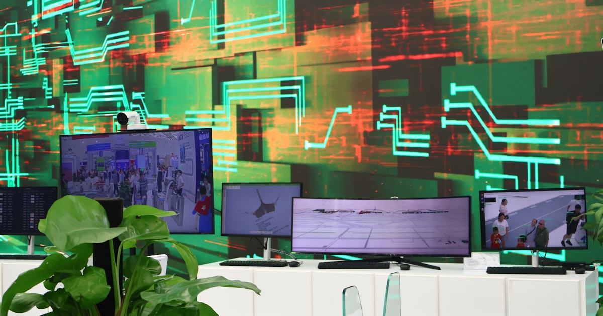 Digital screens display data on a circuit board background