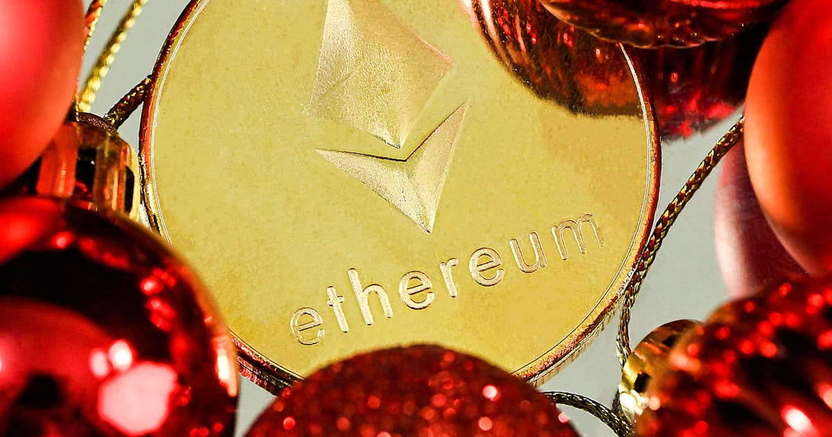 a close up of a red and gold christmas ornament