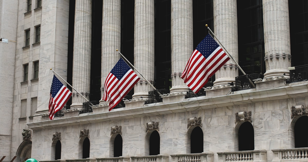 three flag of America on concrete building during daytime