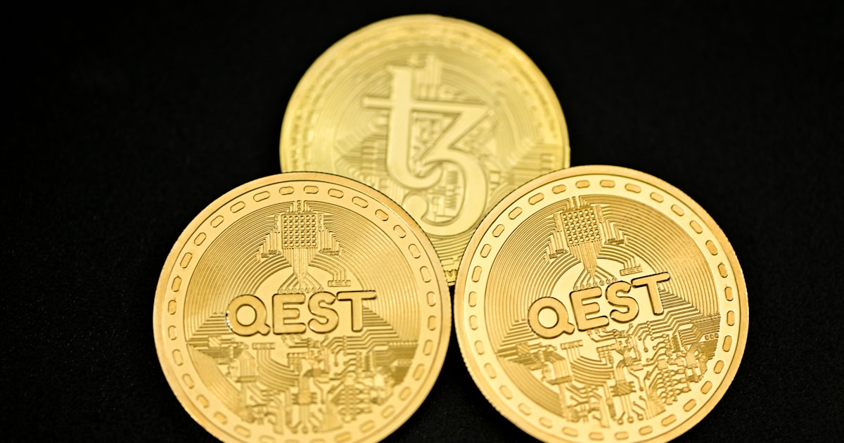 a close up of three gold coins on a black surface