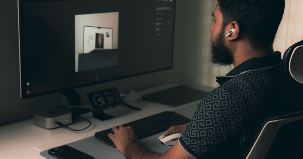 Man working on a computer at a desk.