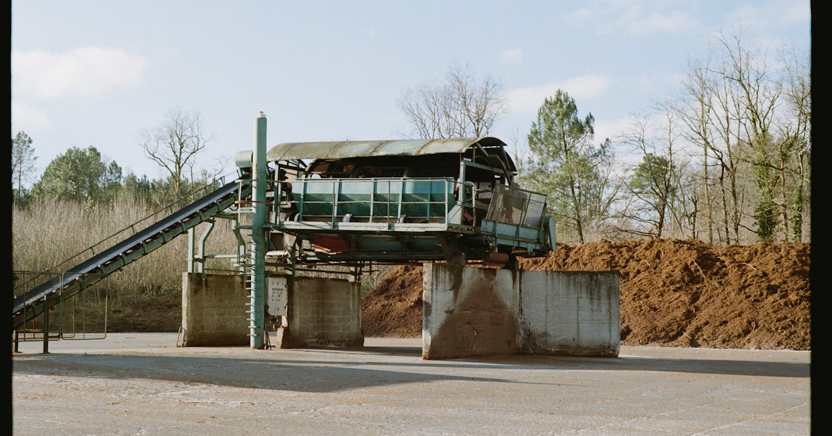Industrial machinery with conveyor belts and piles of material