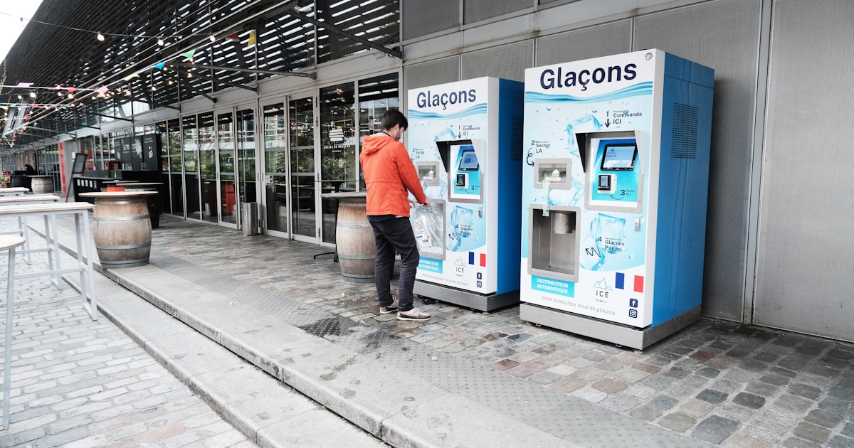 Man uses ice machine in public.