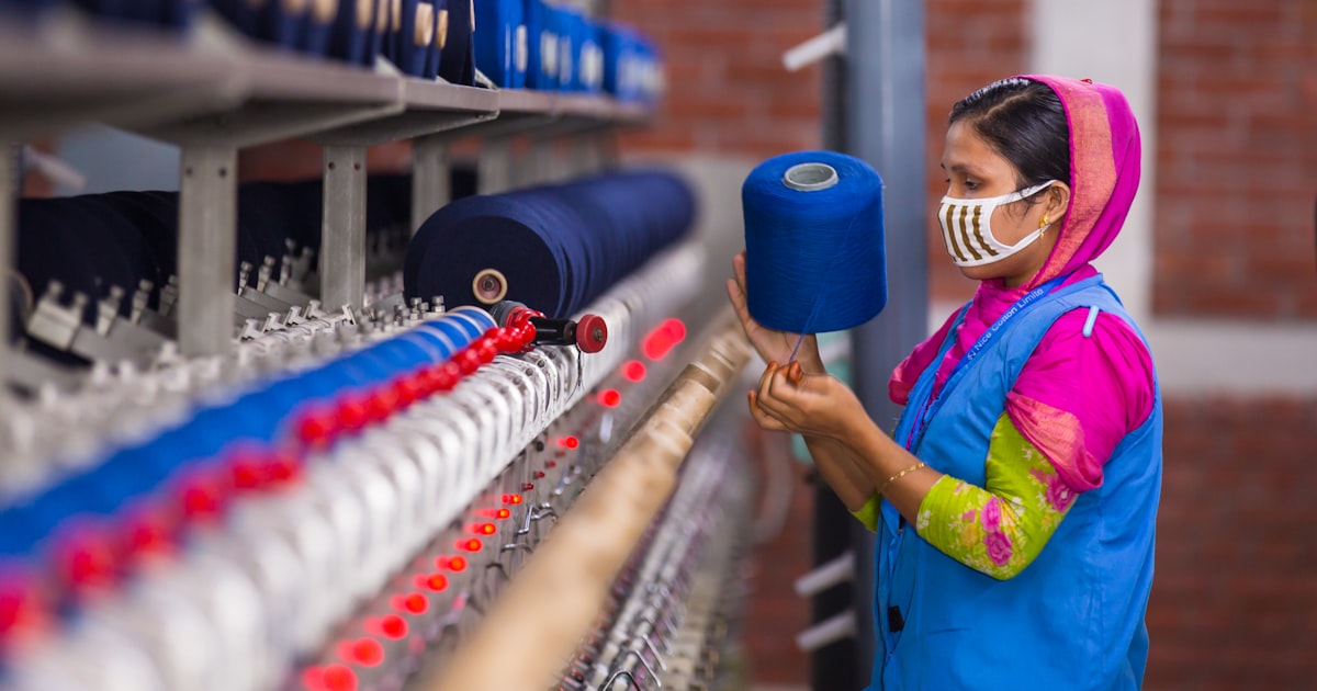 Woman working with blue yarn on a machine
