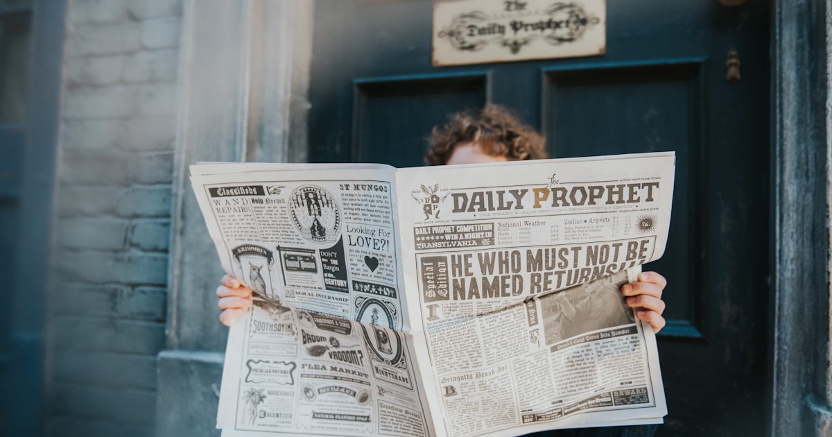 a woman reading a newspaper in front of a door