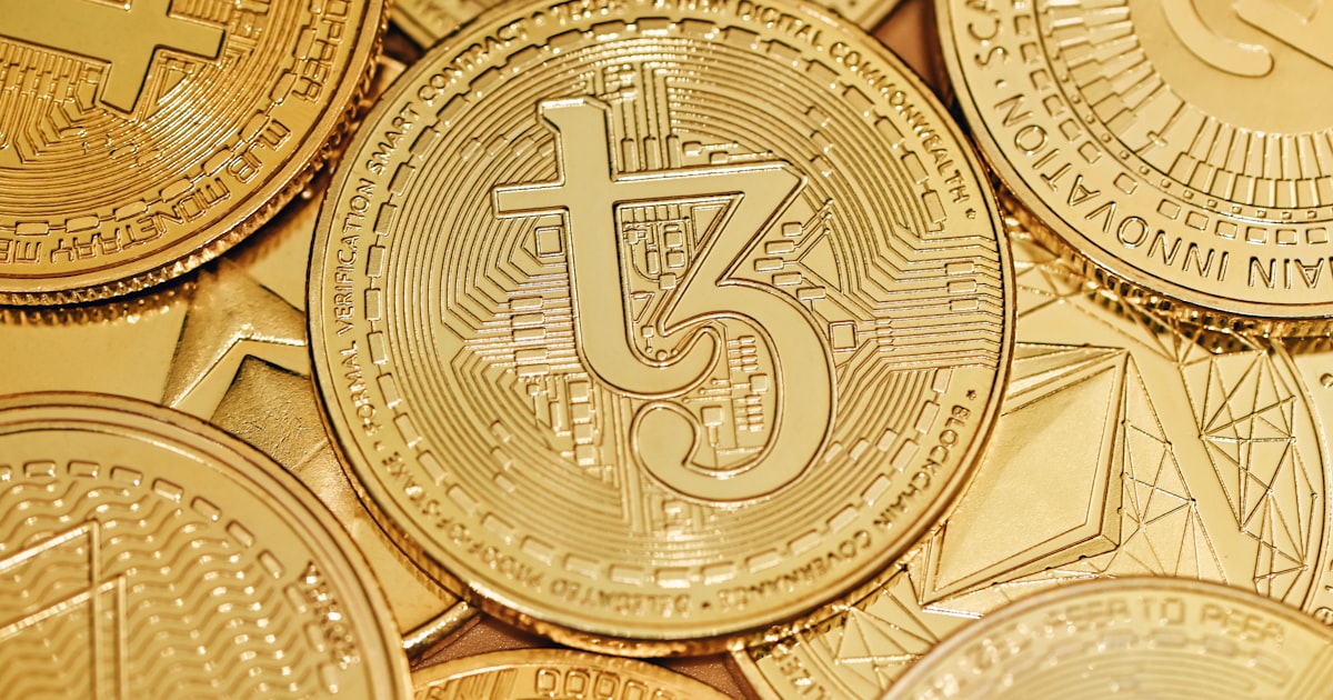 a pile of gold bitcoins sitting on top of each other