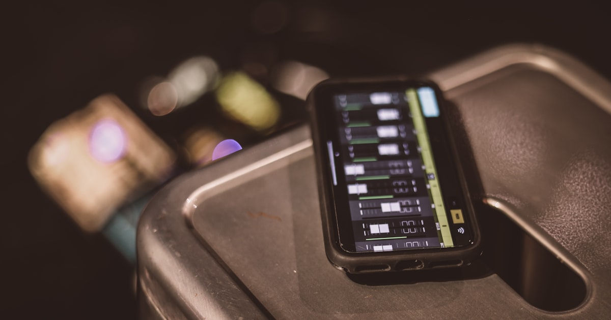 black smartphone on brown table