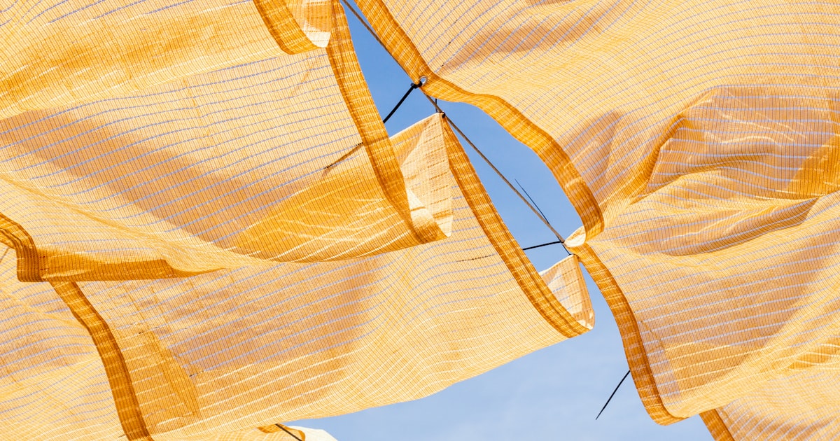 a group of yellow cloths hanging in the air