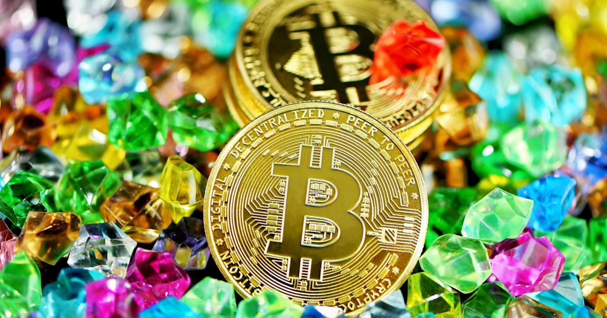 gold round coin on assorted color of flower petals