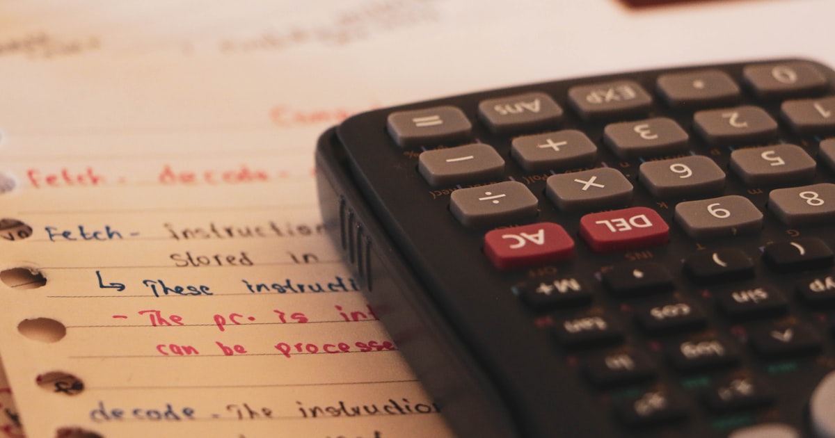 a calculator sitting on top of a piece of paper