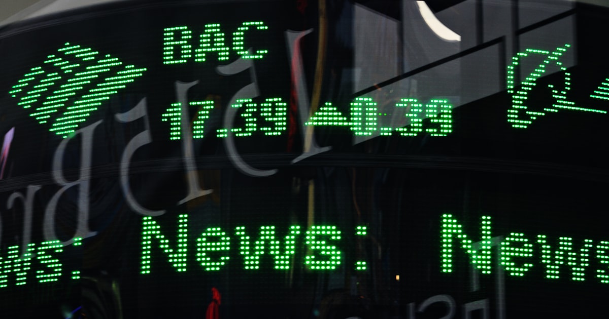 a close up of a clock with green numbers