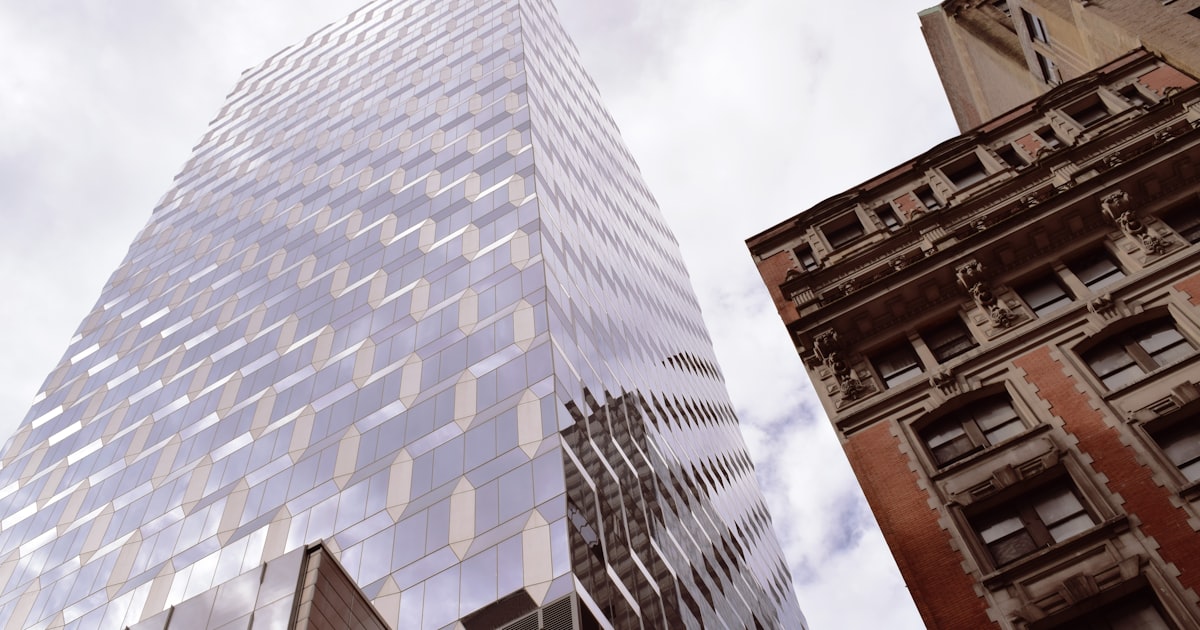 brown concrete building under white clouds during daytime