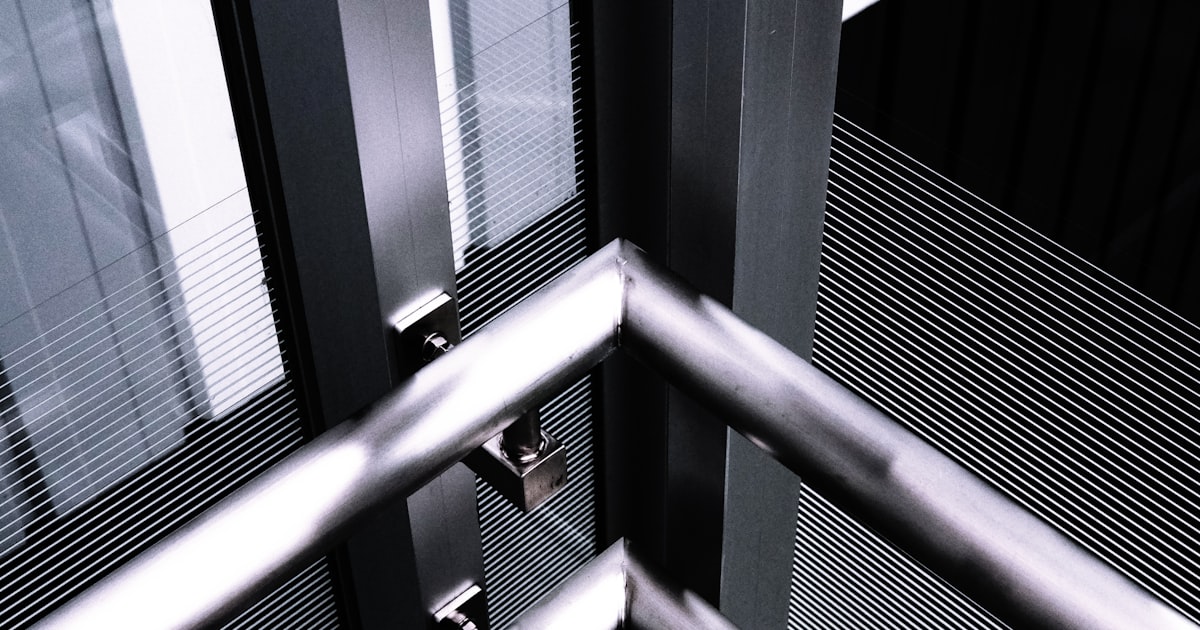 a black and white photo of a metal railing