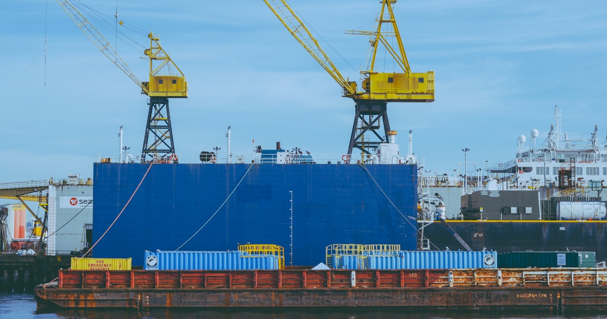 a large blue and yellow boat in the water