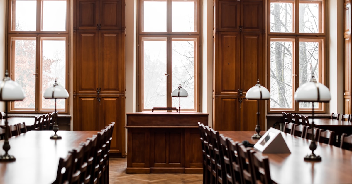 a room filled with lots of wooden tables and chairs