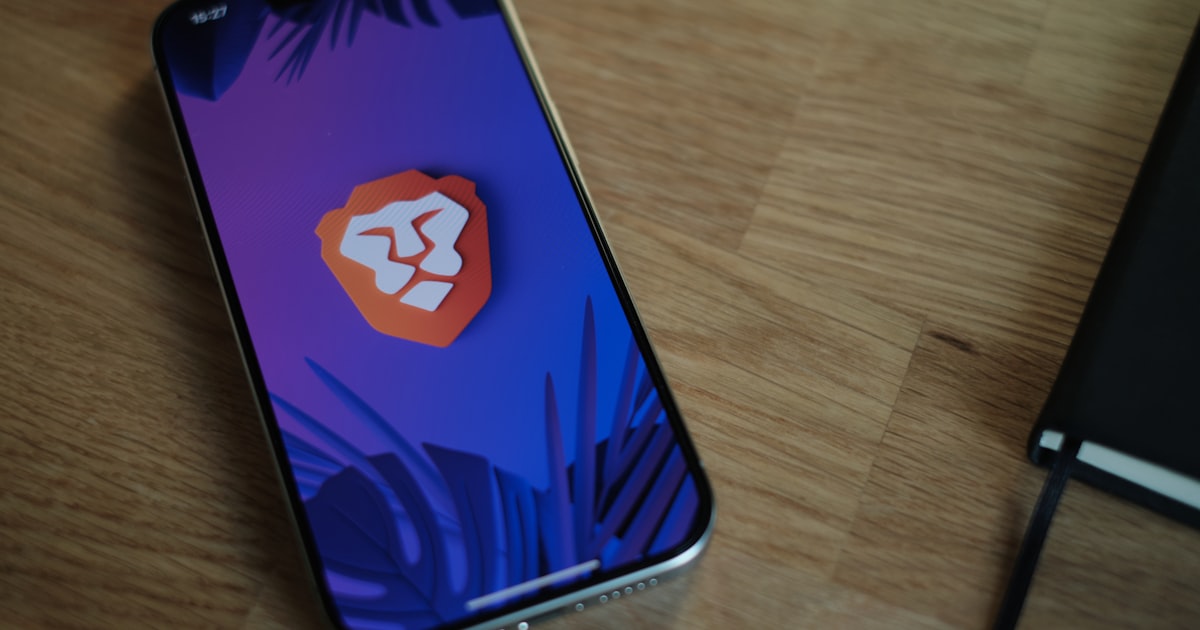 A cell phone sitting on top of a wooden table