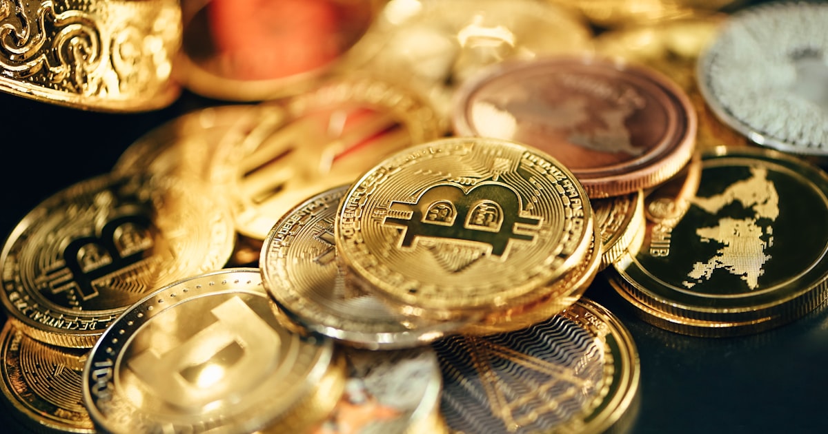 a pile of gold and silver coins sitting on top of a table