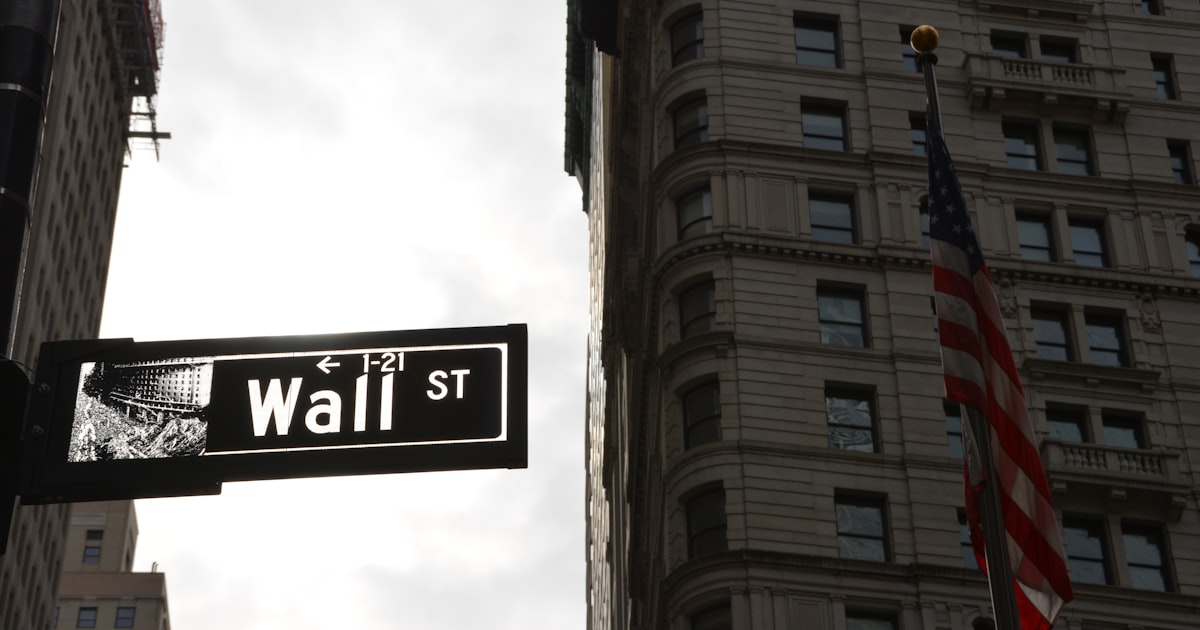 a street sign in front of a tall building