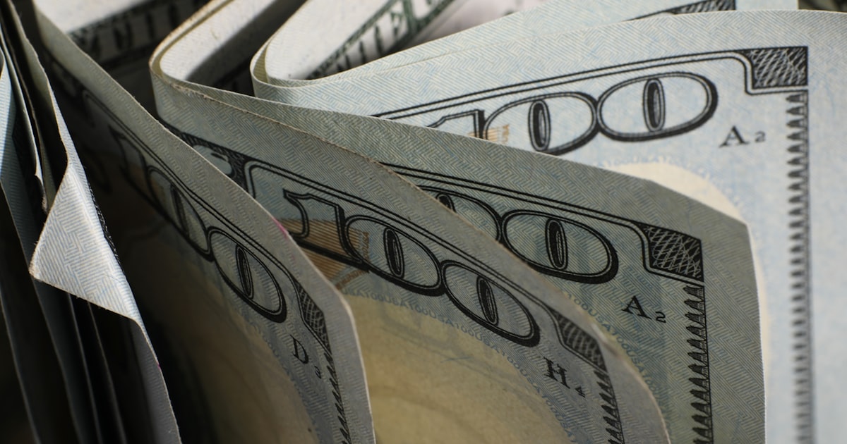 A close-up of us hundred dollar bills fanned out.