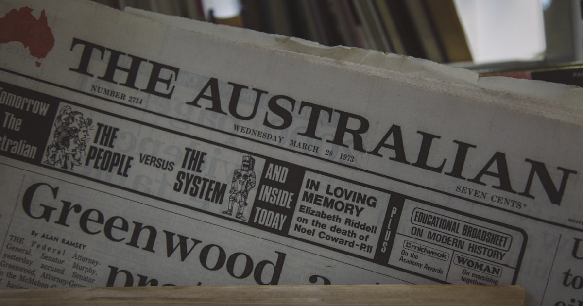 white newspaper on brown wooden table
