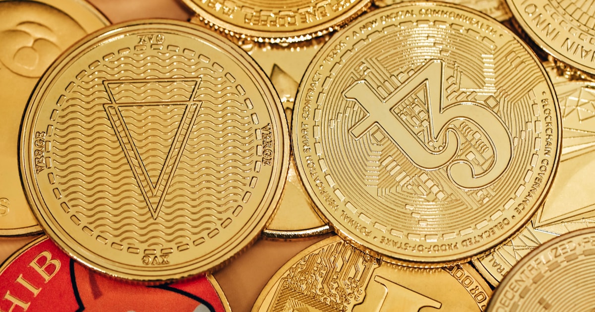a pile of gold bitcoins sitting on top of each other